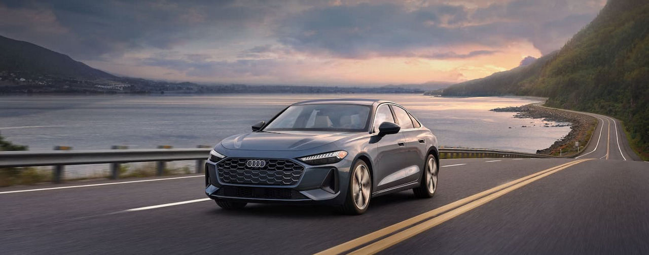 Grey 2025 Audi A5 driving near the ocean